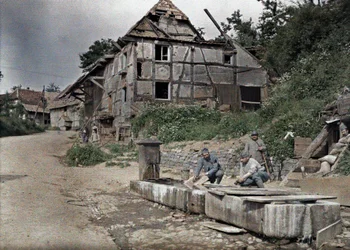 Two French soldiers assigned to a telephone station washing their laundry in a trough, Largitzen, Department Haut-Rhin, Alsace, France, June 18, 1917